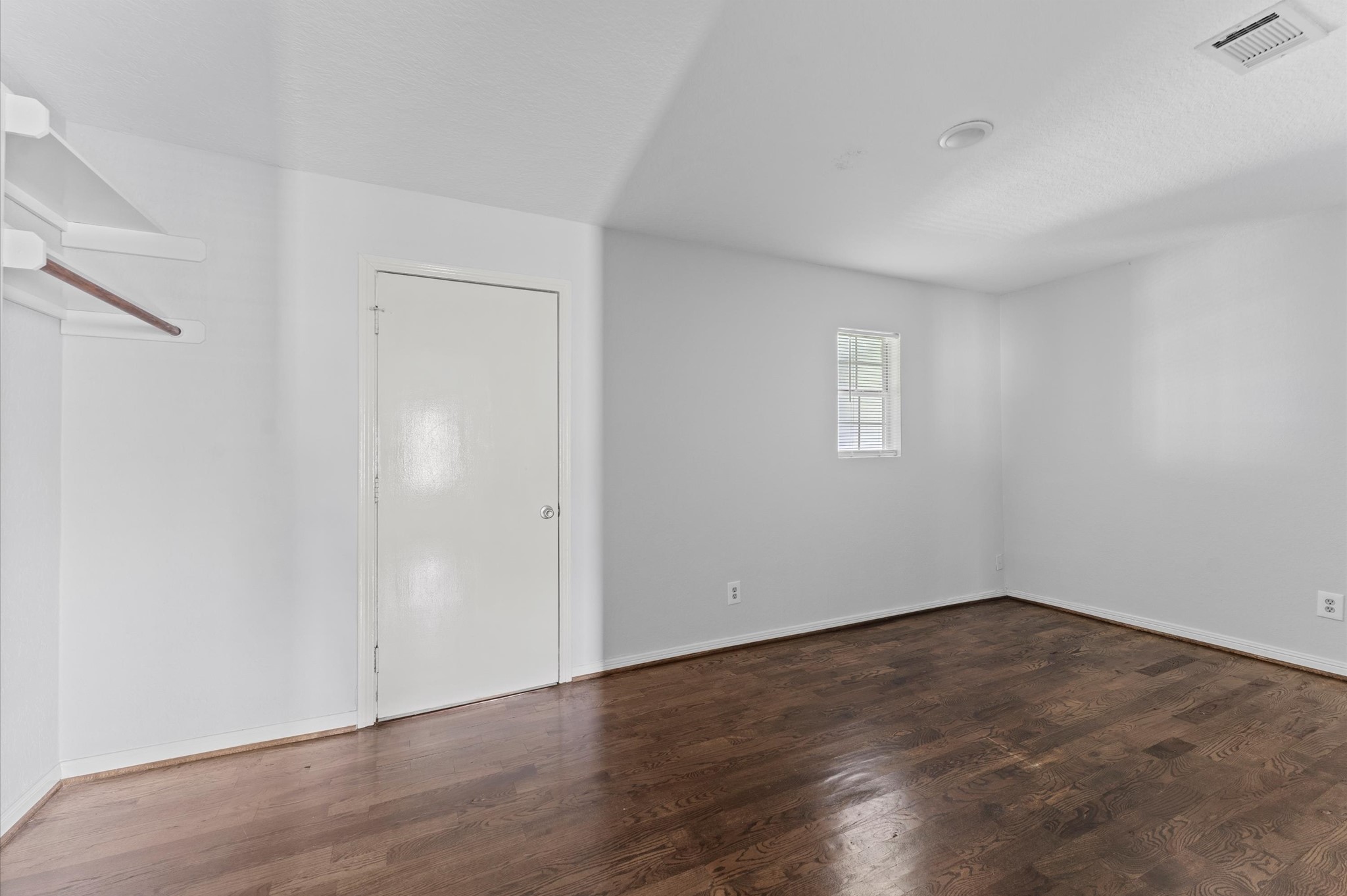 2024 Jean Street Houston, TX 77204 - Photo 11 of 23 an empty room with wooden floor and window