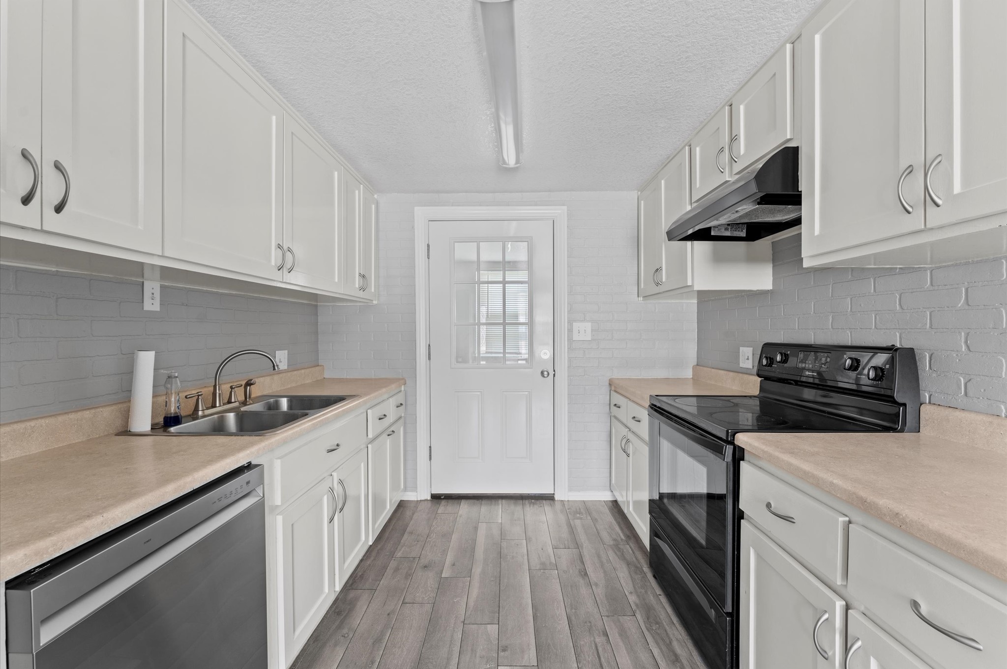 2024 Jean Street Houston, TX 77204 - Photo 13 of 23 a kitchen with stainless steel appliances granite countertop a sink stove and cabinets