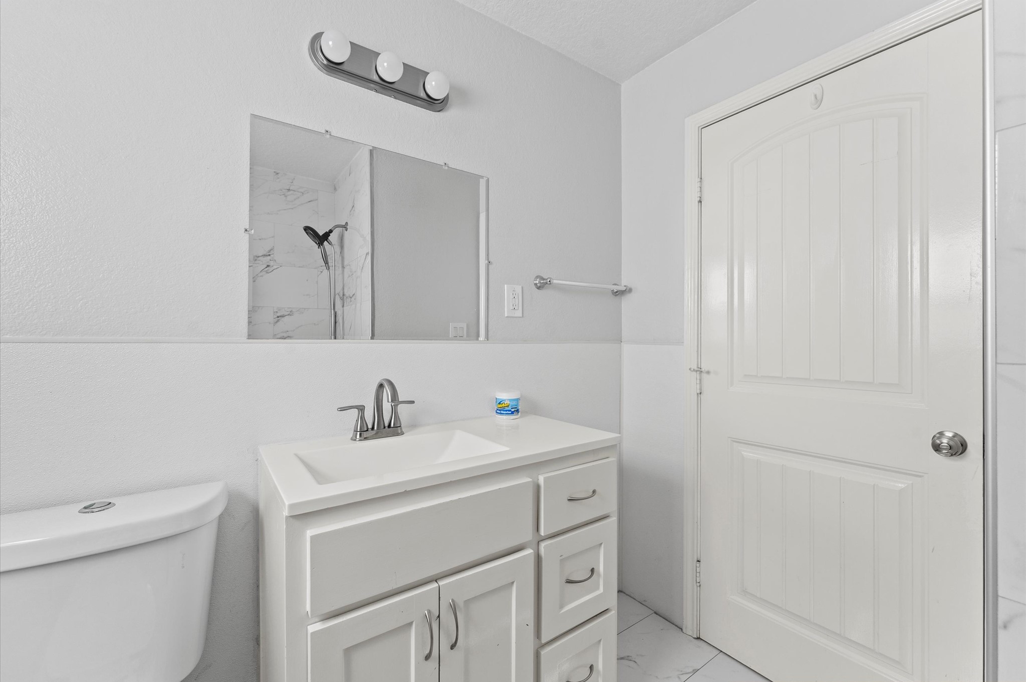 2024 Jean Street Houston, TX 77204 - Photo 16 of 23 a bathroom with a sink toilet vanity and a tub