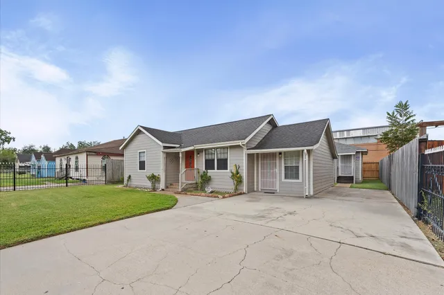 a front view of a house with a garden and yard