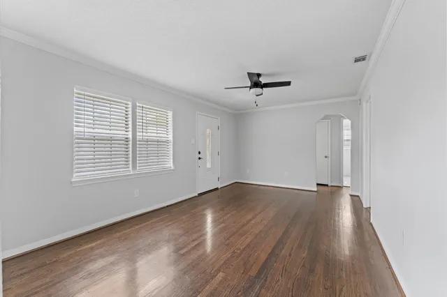 wooden floor in an empty room with a window