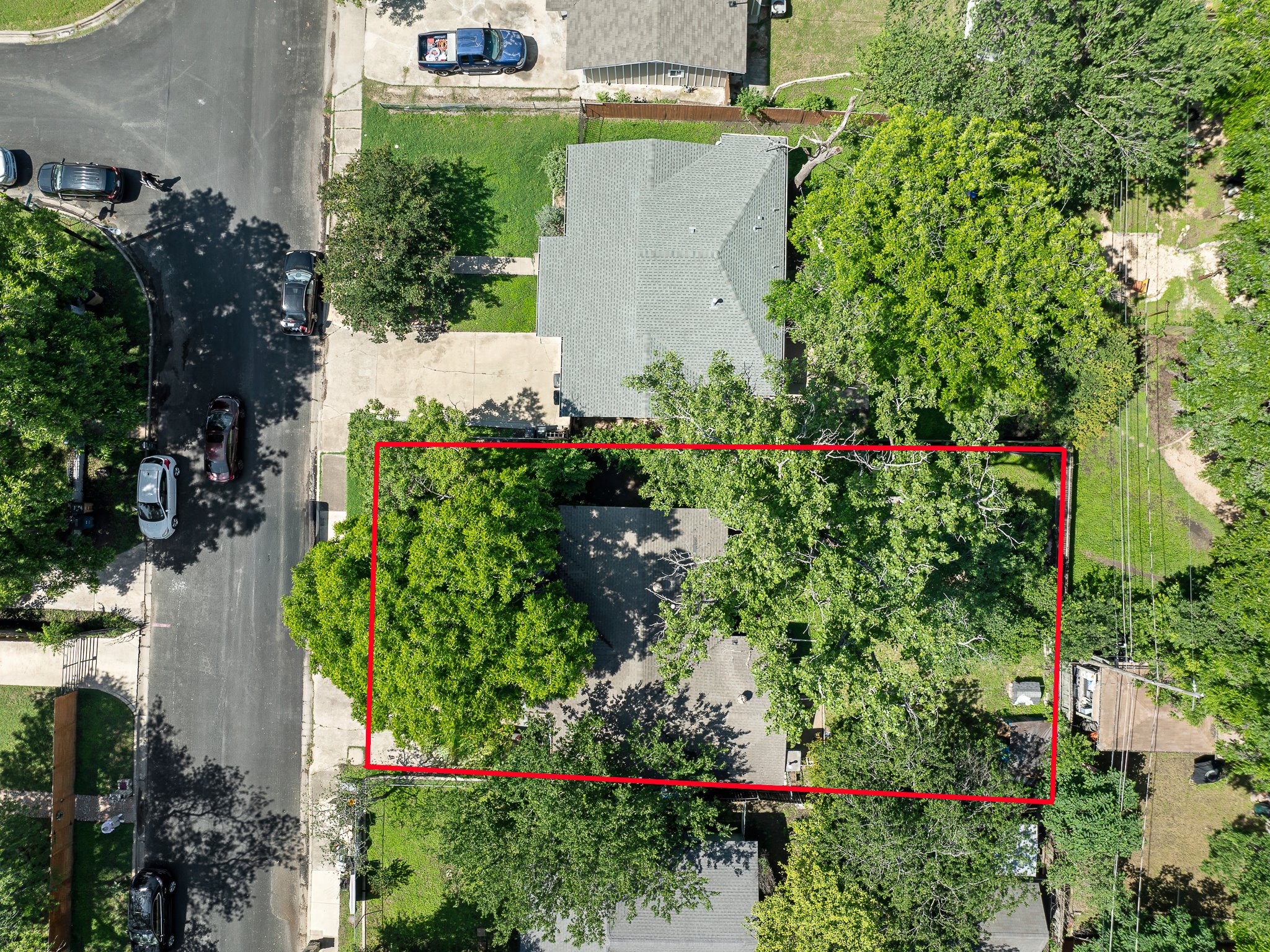 1122 Spur Street, Unit D Austin, TX 78721 - Photo 3 of 6 Aerial perspective showcasing the property with abundant mature trees and a residential street frontage