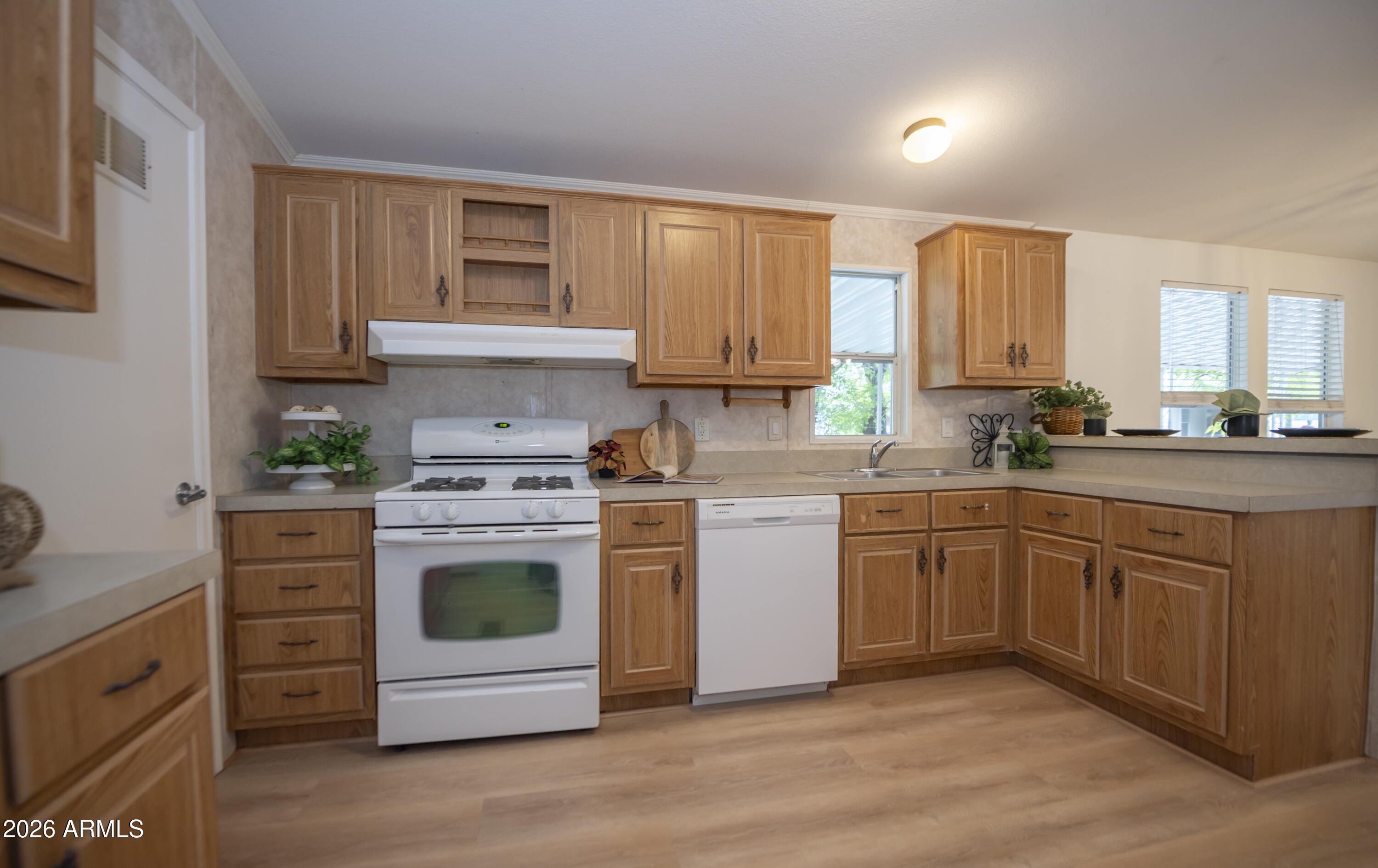 11250 East State Rte 69, Unit 1125 Dewey, AZ 86327 - Photo 13 of 45 a kitchen with stainless steel appliances granite countertop a stove a sink and white cabinets