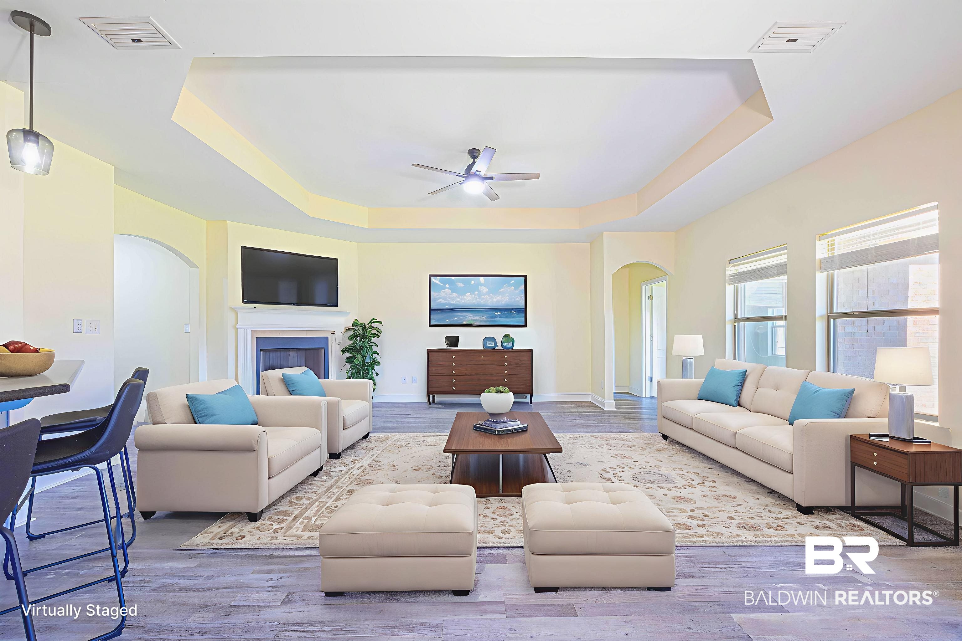 25234 Fairfax Road Daphne, AL 36526 - Photo 20 of 45 Living area featuring arched walkways, a tray ceiling, wood finished floors, ceiling fan, and a fireplace