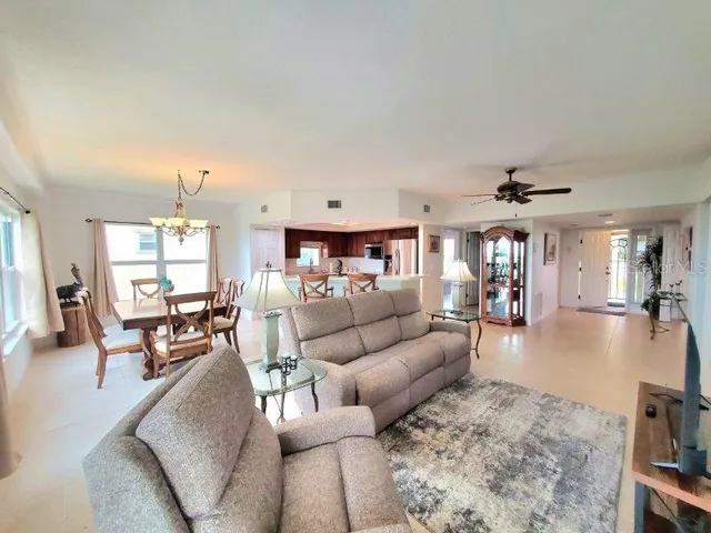 a living room with furniture and a chandelier