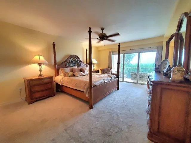 a spacious bedroom with a bed and large windows