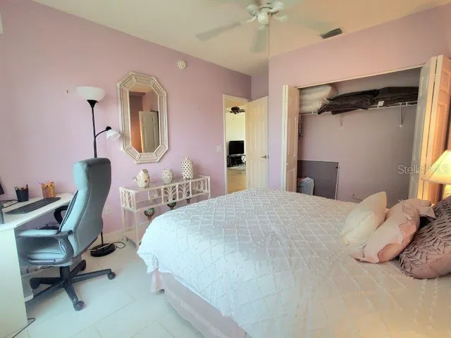 a bedroom with a bed a desk and chair