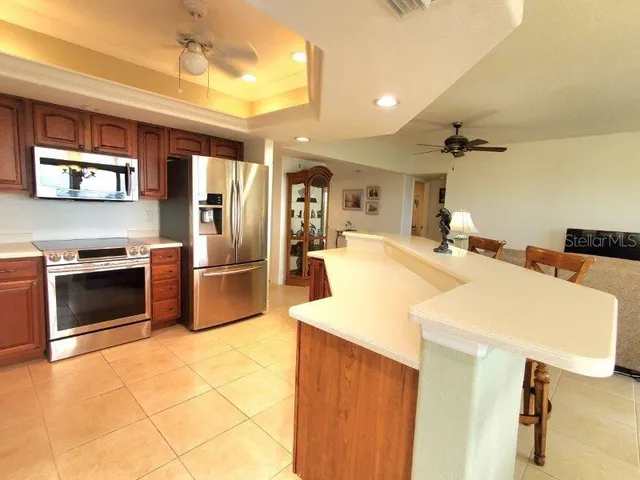a kitchen with stainless steel appliances a stove a sink and a refrigerator