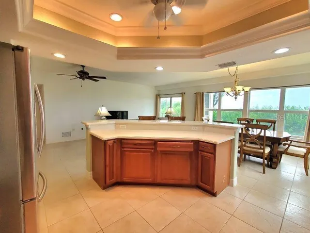 a large kitchen with stainless steel appliances a sink and cabinets