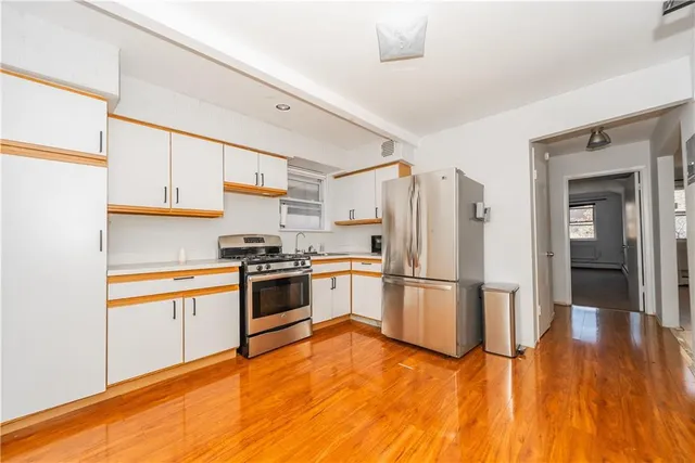 a kitchen with a wooden floor and a stove top oven