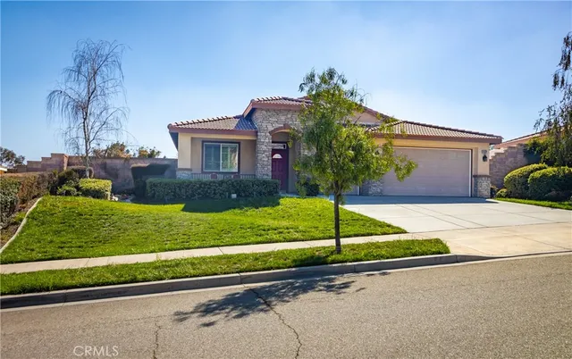 a house with green field in front of it