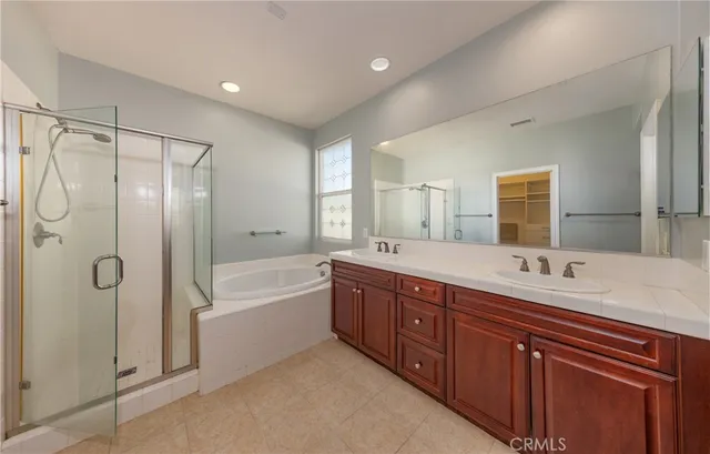 a spacious bathroom with a double vanity sink mirror double and shower