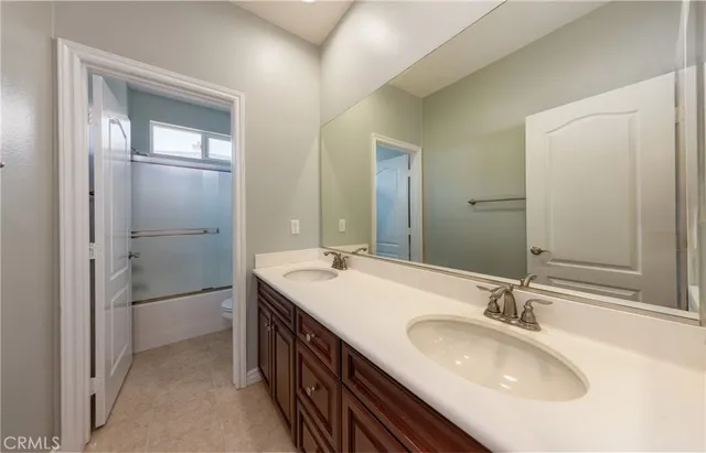a bathroom with a double vanity sink and a mirror