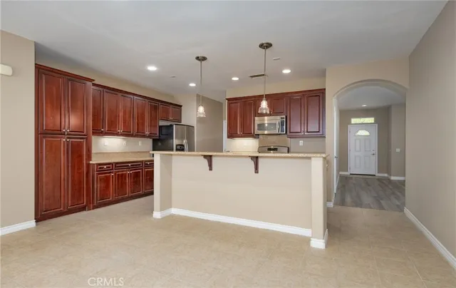a kitchen with stainless steel appliances granite countertop a refrigerator sink and cabinets
