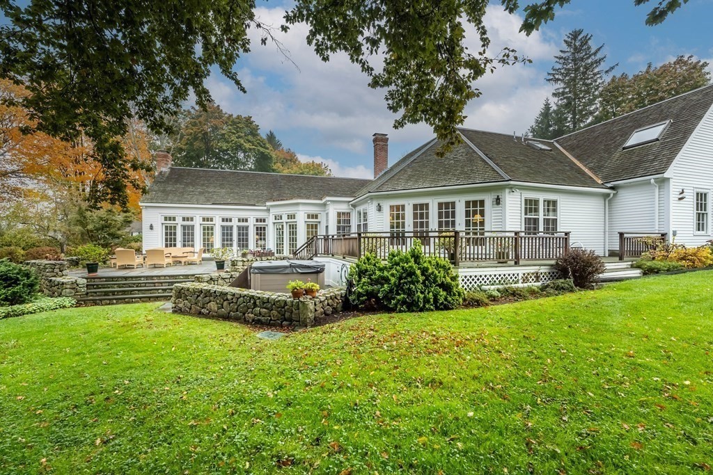 9 A Bancroft Road Andover, MA 01810 - Photo 1 of 37 a front view of a house with a yard table and chairs