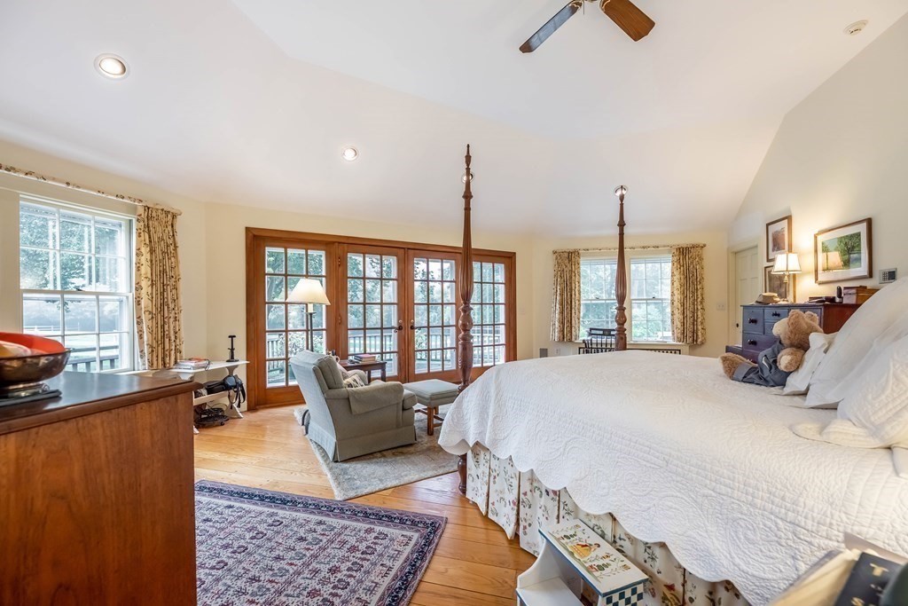 9 A Bancroft Road Andover, MA 01810 - Photo 23 of 37 a bed room with a bed a couch and a chandelier
