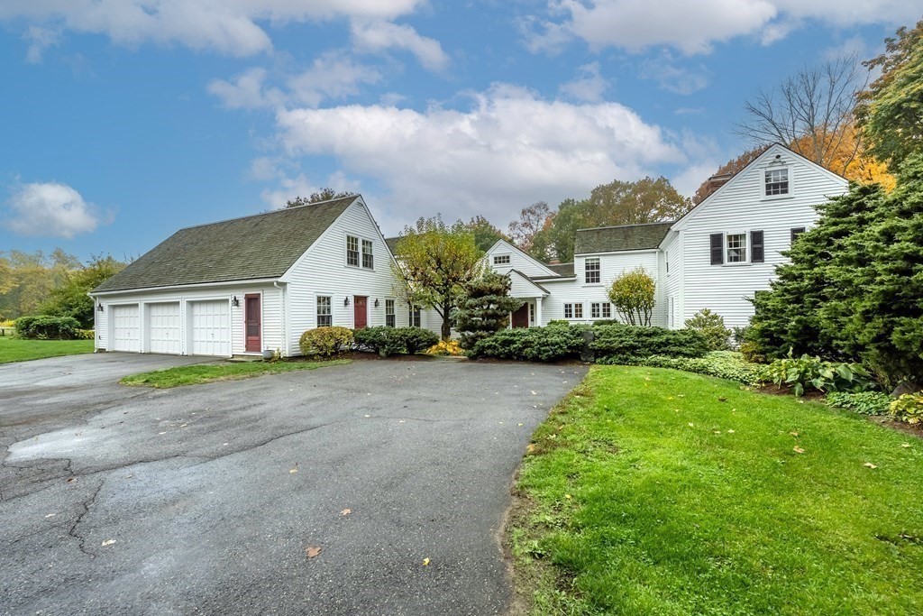 9 A Bancroft Road Andover, MA 01810 - Photo 3 of 37 a front view of a house with a yard and garage