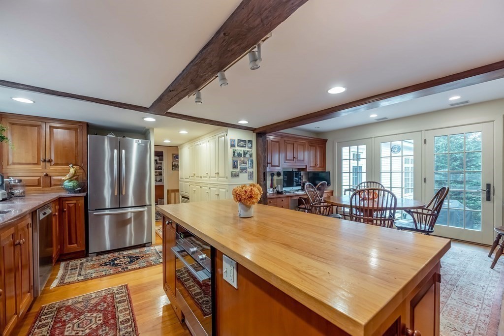 9 A Bancroft Road Andover, MA 01810 - Photo 8 of 37 a kitchen with stainless steel appliances granite countertop a sink a stove and refrigerator