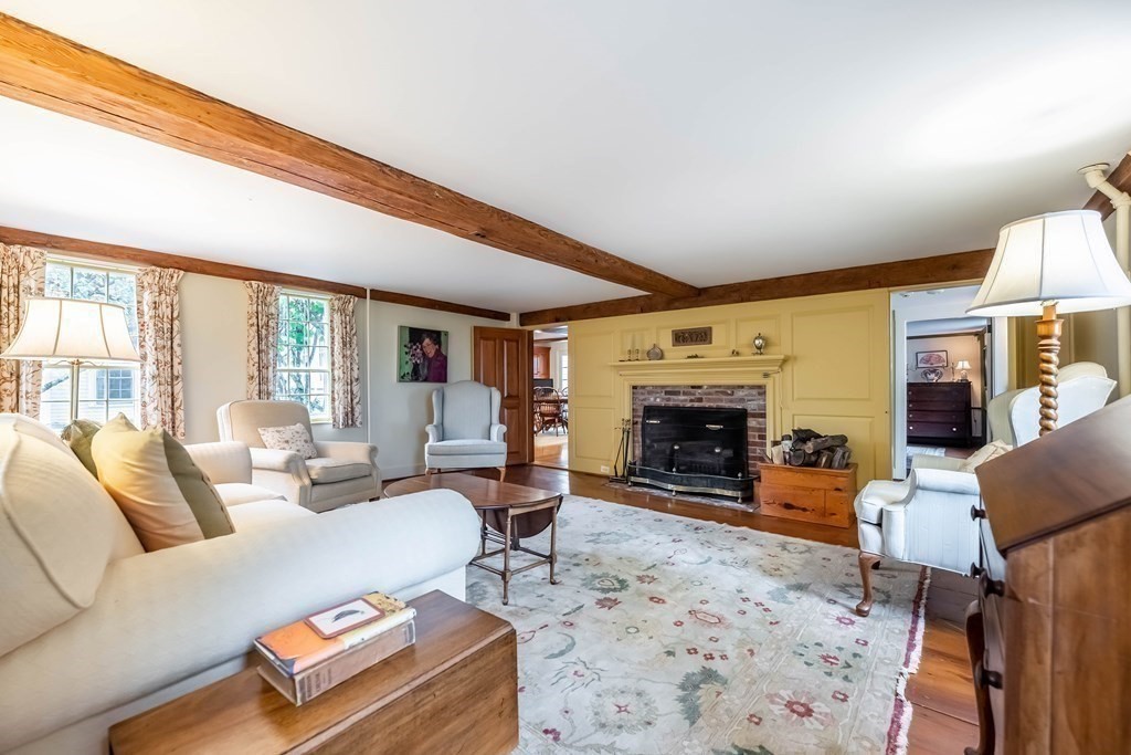 9 A Bancroft Road Andover, MA 01810 - Photo 9 of 37 a living room with furniture a fireplace and a table