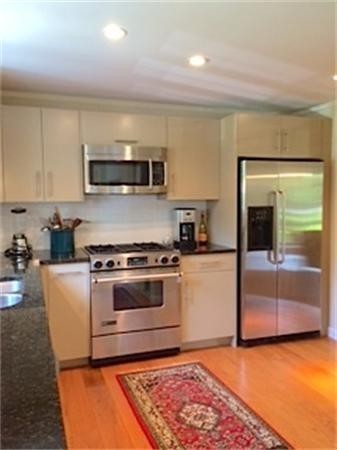 29 Harkness Road Pelham, MA 01002 - Photo 10 of 30 a kitchen with stainless steel appliances granite countertop a stove a sink and a microwave