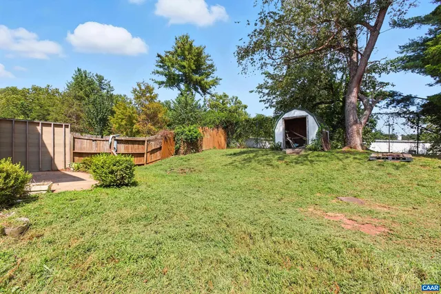 a view of a backyard with table and chairs and potted plants