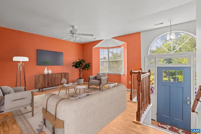 a living room with furniture a chandelier and a fireplace