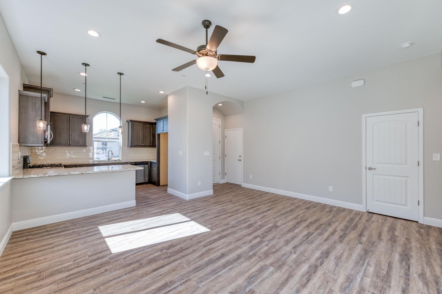 778 Shasta Street Madera, CA 93638 - Photo 11 of 28 a view of a kitchen with wooden floor and a ceiling fan