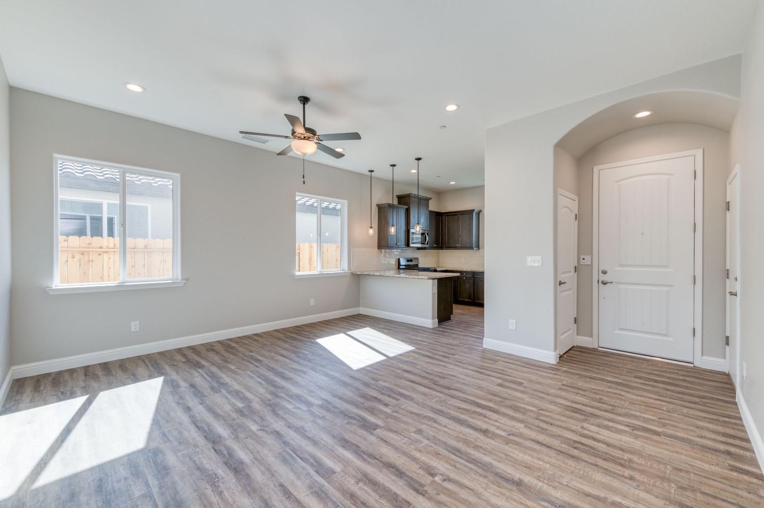 778 Shasta Street Madera, CA 93638 - Photo 12 of 28 a view of kitchen and empty room with wooden floor