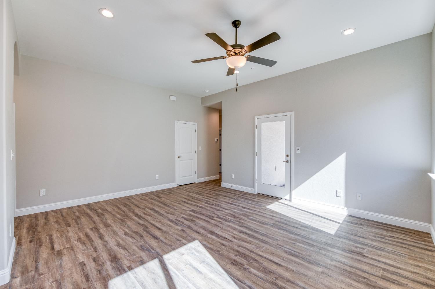 778 Shasta Street Madera, CA 93638 - Photo 14 of 28 an empty room with wooden floor and a ceiling fan