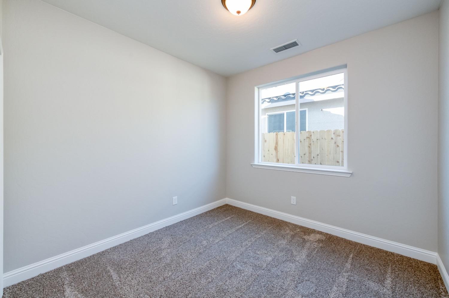 778 Shasta Street Madera, CA 93638 - Photo 18 of 28 an empty room with chandelier fan