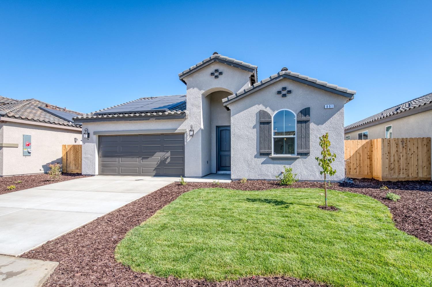 778 Shasta Street Madera, CA 93638 - Photo 3 of 28 a front view of a house with a yard and garage