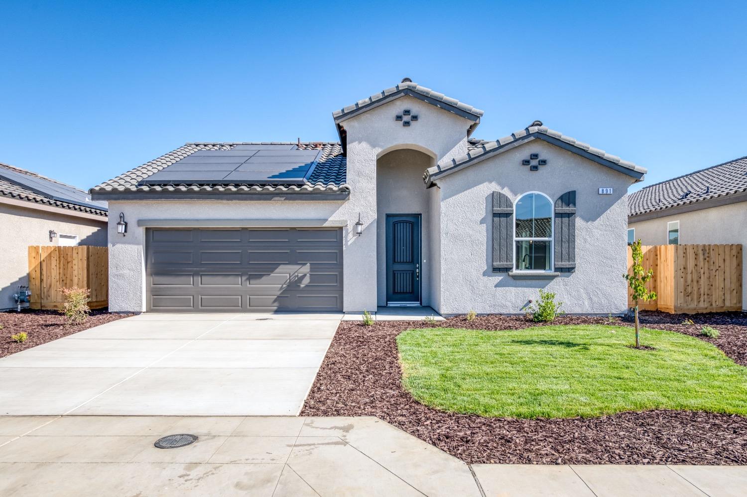 778 Shasta Street Madera, CA 93638 - Photo 4 of 28 a front view of a house with a yard