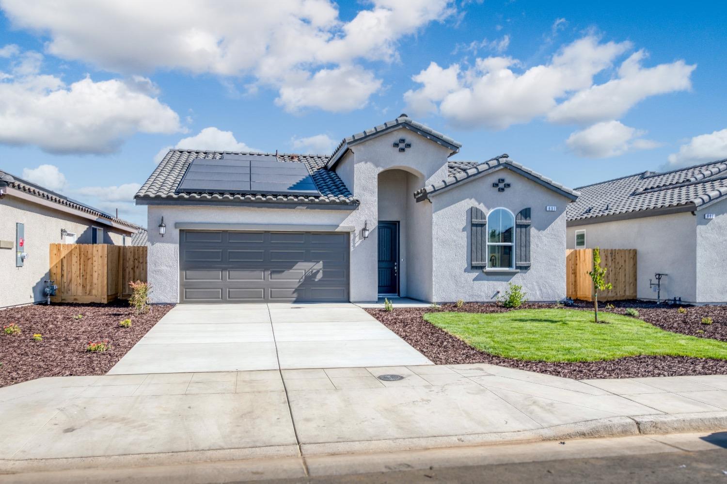 778 Shasta Street Madera, CA 93638 - Photo 5 of 28 a front view of a house with a yard and garage