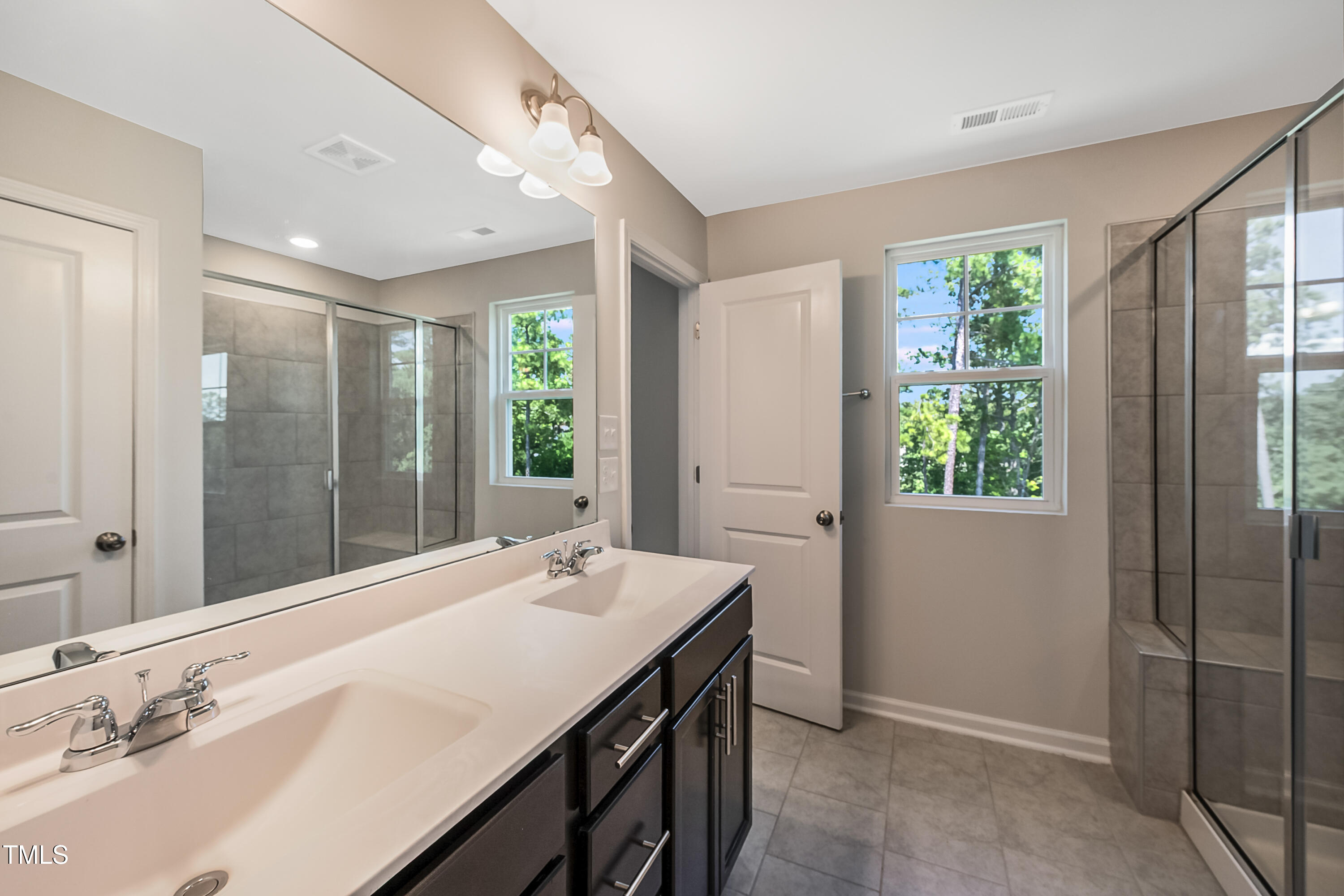 1032 Shoreside Drive Durham, NC 27713 - Photo 13 of 31 a bathroom with a granite countertop sink a large mirror and a bathtub