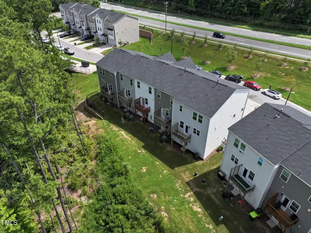 an aerial view of a house with swimming pool and garden