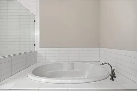 a bathroom with a tub a sink and a shower