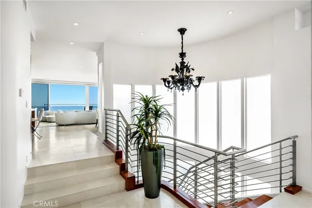 a living room with furniture and a view of kitchen