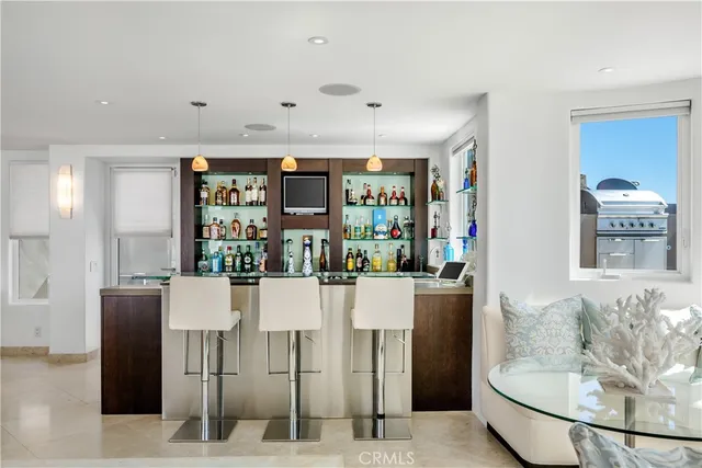 a view of a patio with lawn chairs next to an ocean