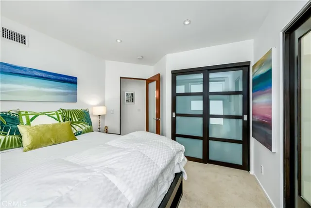 a bedroom with a bed and glass windows