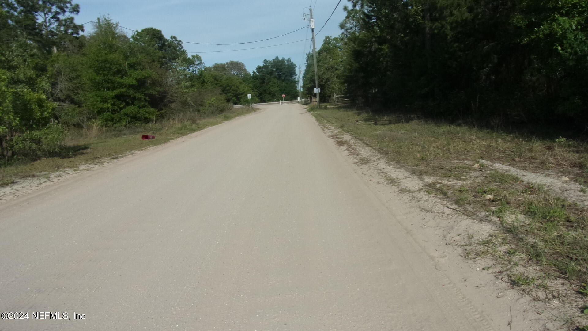 189 Poplar Drive Interlachen, FL 32148 - Photo 6 of 6 a view of a road with a trees in the background