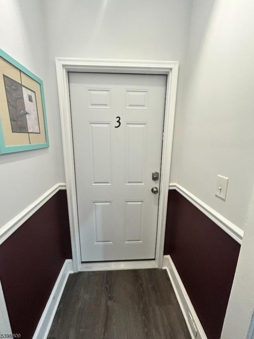 142 Mapes Avenue, Unit 3 Newark, NJ 07112 - Photo 1 of 8 an empty room with wooden floor and staircase