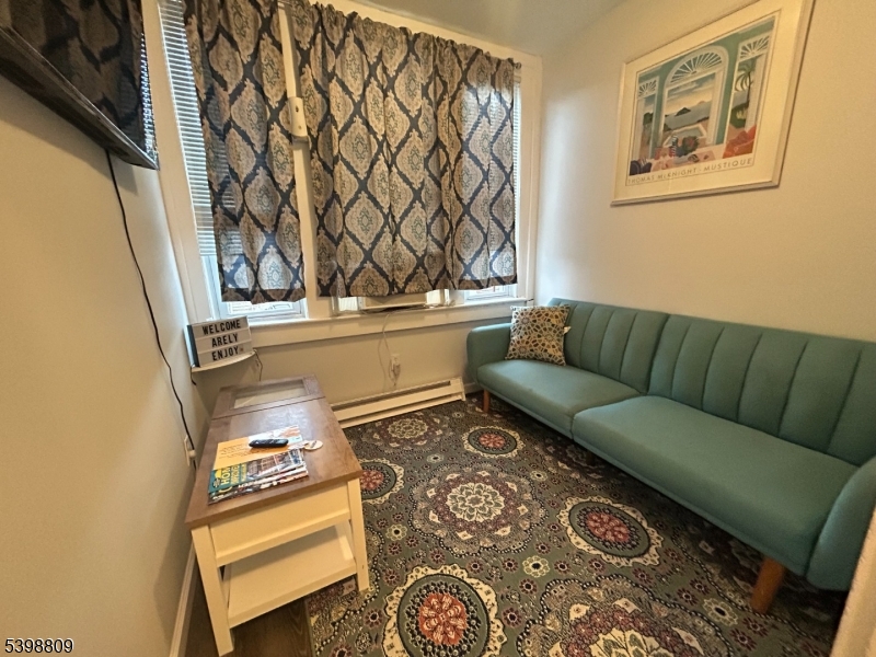 142 Mapes Avenue, Unit 3 Newark, NJ 07112 - Photo 2 of 8 a living room with a couch and a table