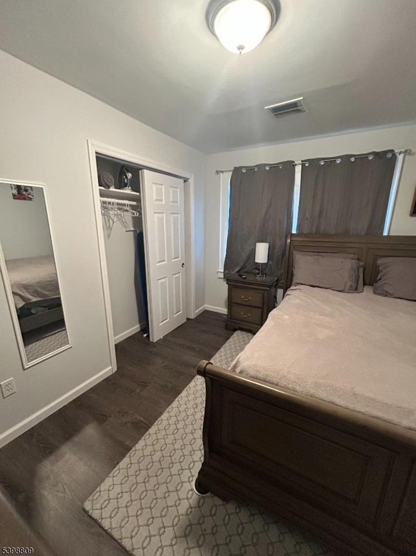 142 Mapes Avenue, Unit 3 Newark, NJ 07112 - Photo 7 of 8 a bedroom with a bed and wooden floor