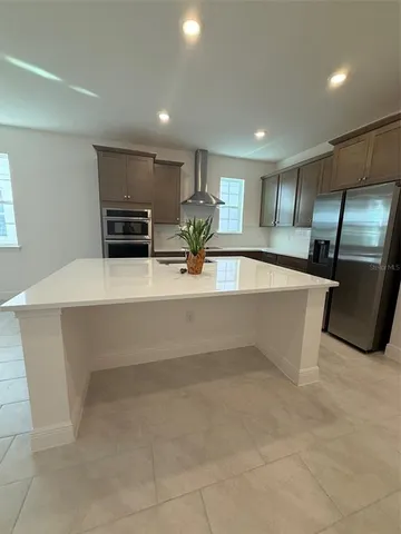a view of kitchen with stainless steel appliances cabinets