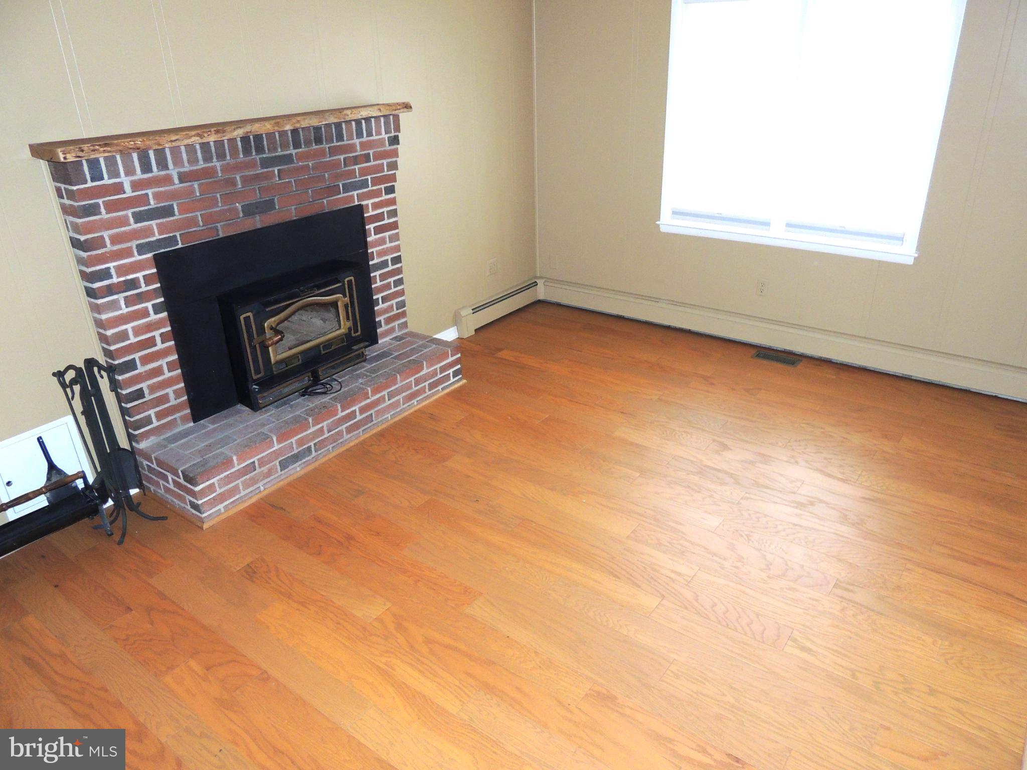 5838 Oklahoma Road Sykesville, MD 21784 - Photo 37 of 72 Cozy space with a charming fireplace.