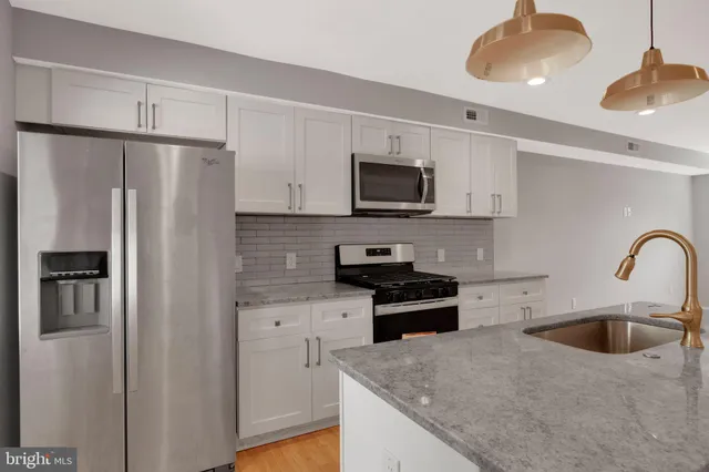 a kitchen that has a sink and a stove