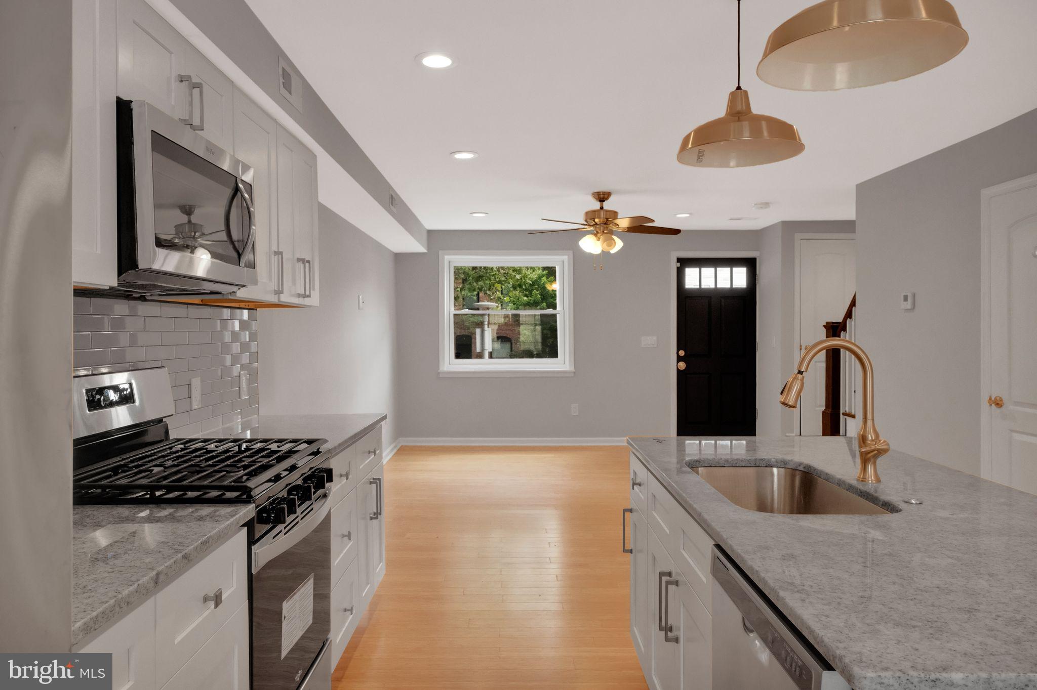 245 South Clinton Street Baltimore, MD 21224 - Photo 12 of 39 a kitchen that has a sink and a stove