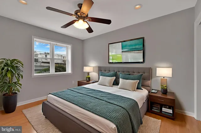 a view of a big room with wooden floor and windows