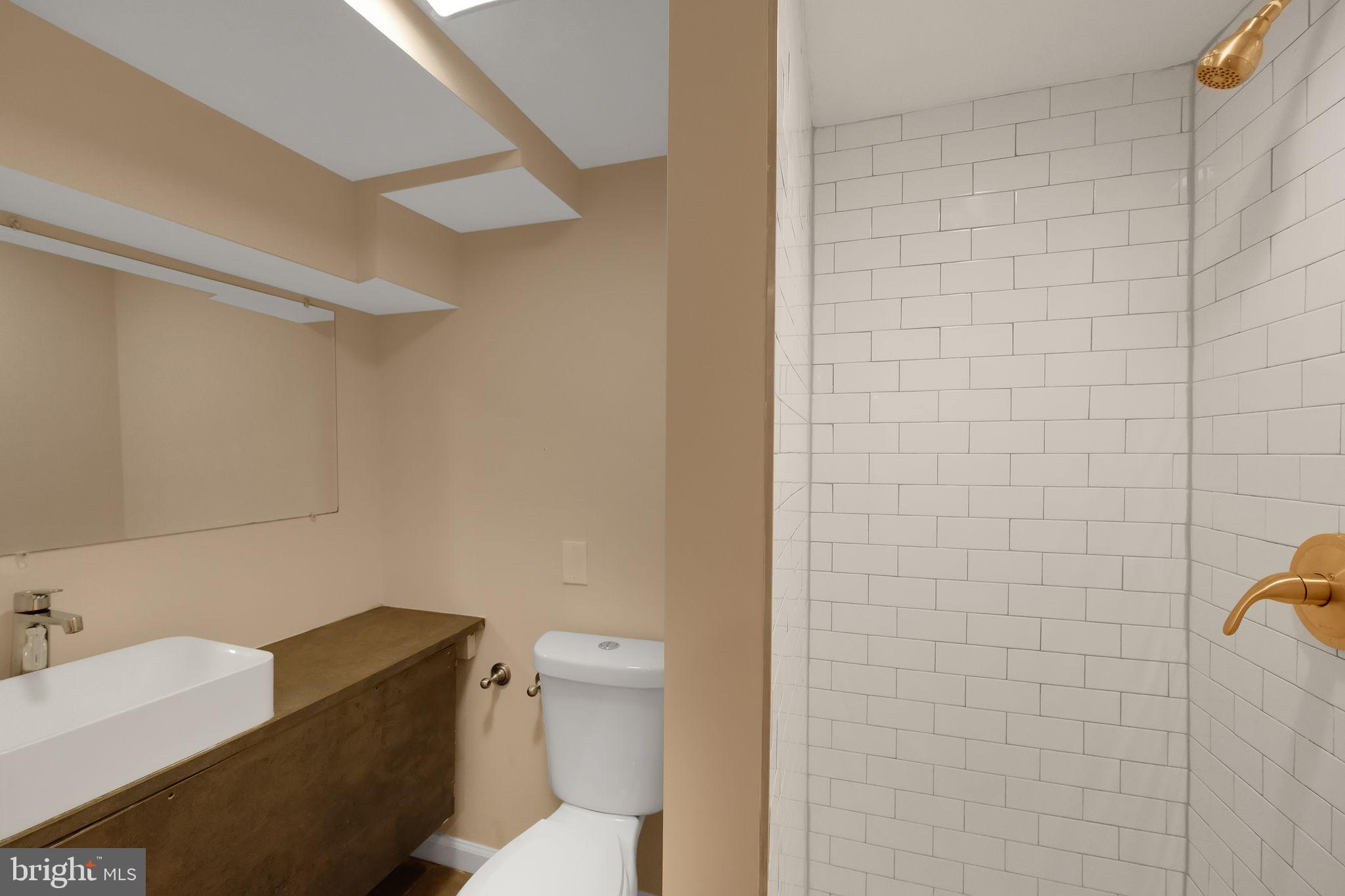 245 South Clinton Street Baltimore, MD 21224 - Photo 30 of 39 a bathroom with a toilet and a shower