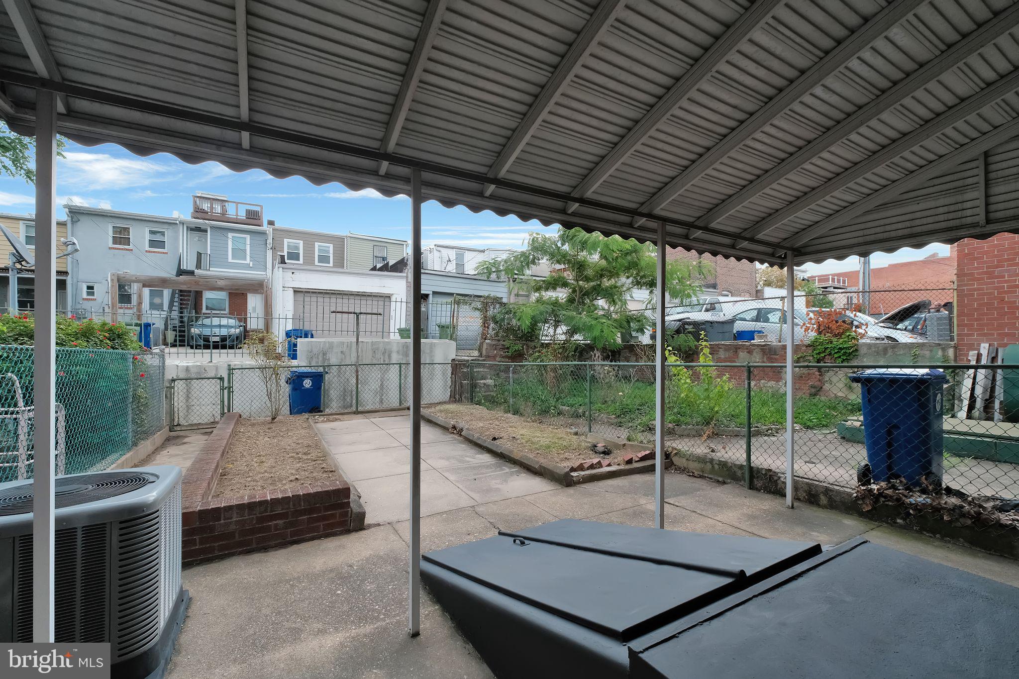 245 South Clinton Street Baltimore, MD 21224 - Photo 35 of 39 a view of a patio with a table and chairs